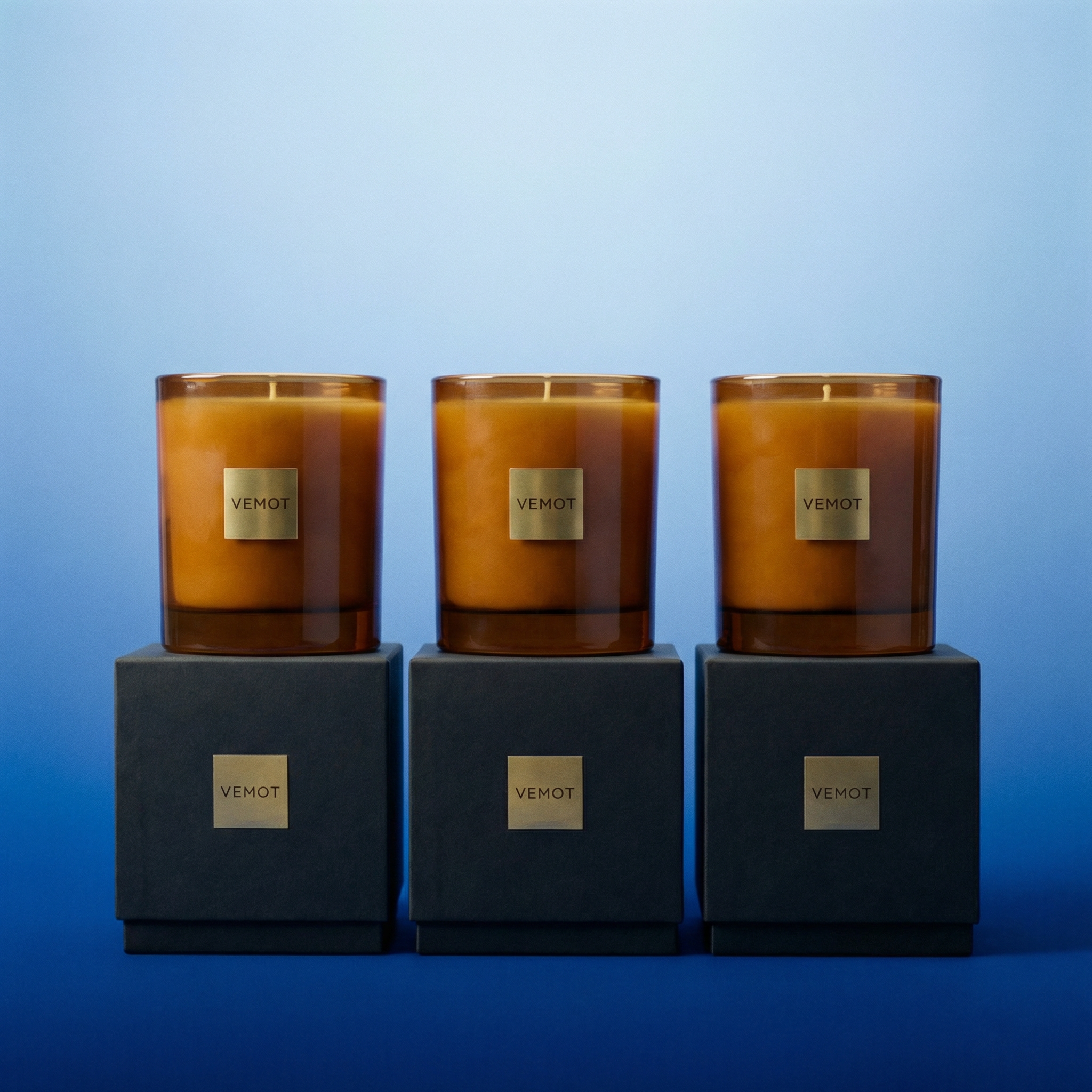 VEMOT Gift Set — 3 candles standing on top of 3 gift boxes in a row