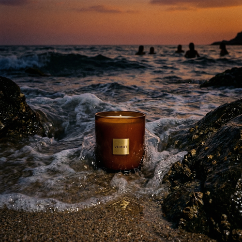 VEMOT Nightswimming candle on Mediterranean beach sand and wet rocks at night
