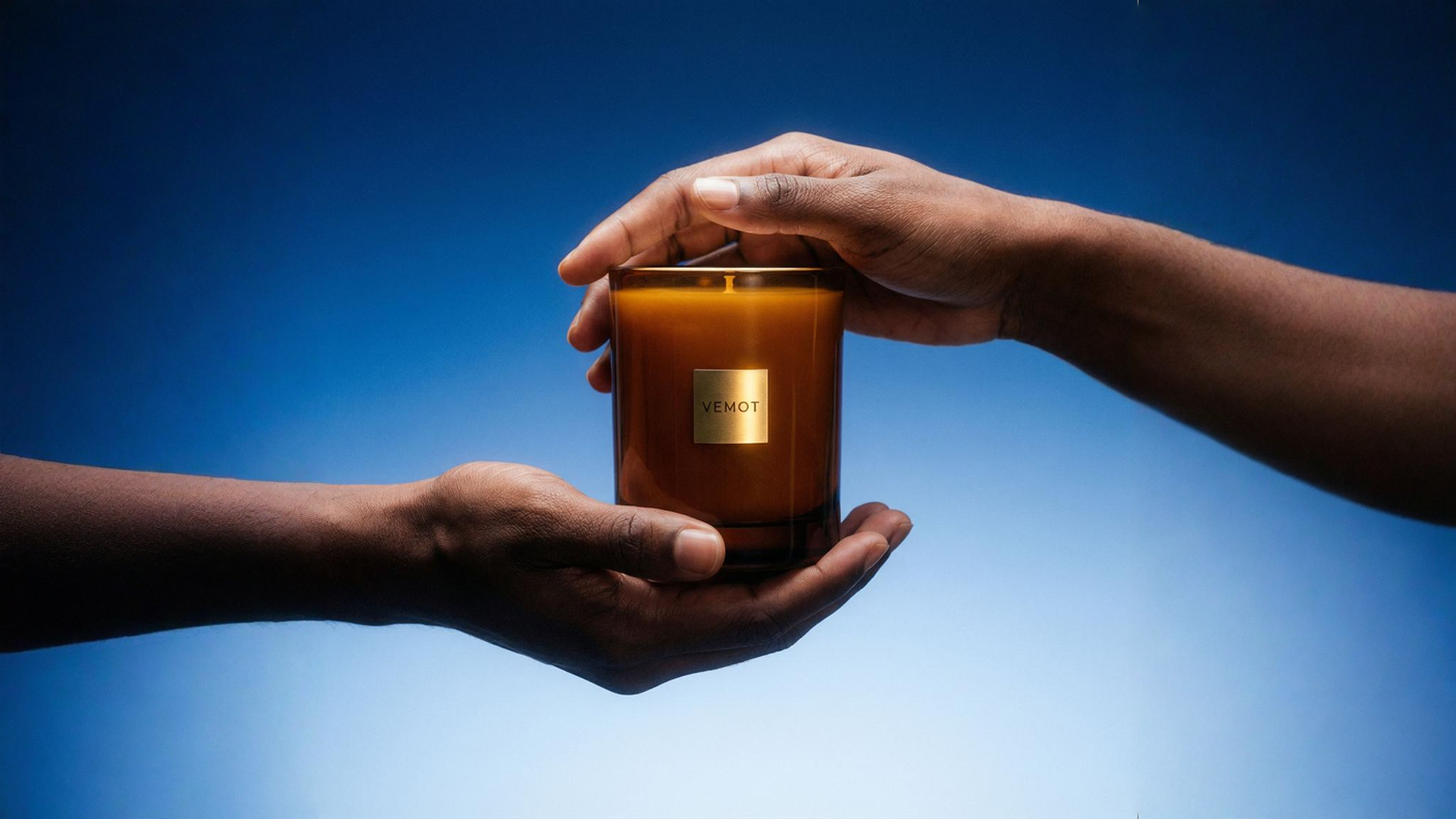 Hands holding scented candle